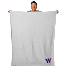 Photo of A Man Holding Up Sweatshirt Throw Blanket.