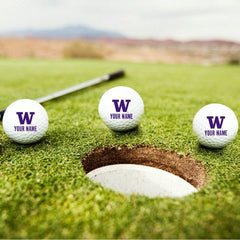 Photo of There are three CDI W logo golf balls resting on a golf course..