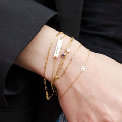 A woman's hand is adorned with a Cavan Gold "Kyle Cavan Washington Dubs Up" bracelet. Hover